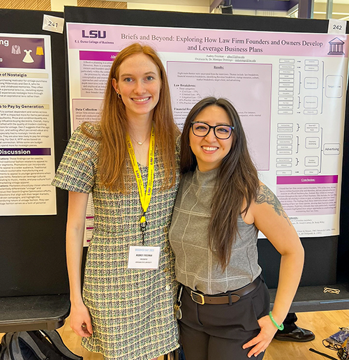 Audry Freeman and Monique Domingo stand in front of a research poster at LSU Discovery Day 2025