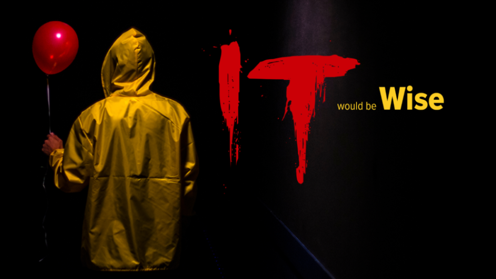 It would be wise It would be wise. Man in yellow rain jacket holding red balloon.