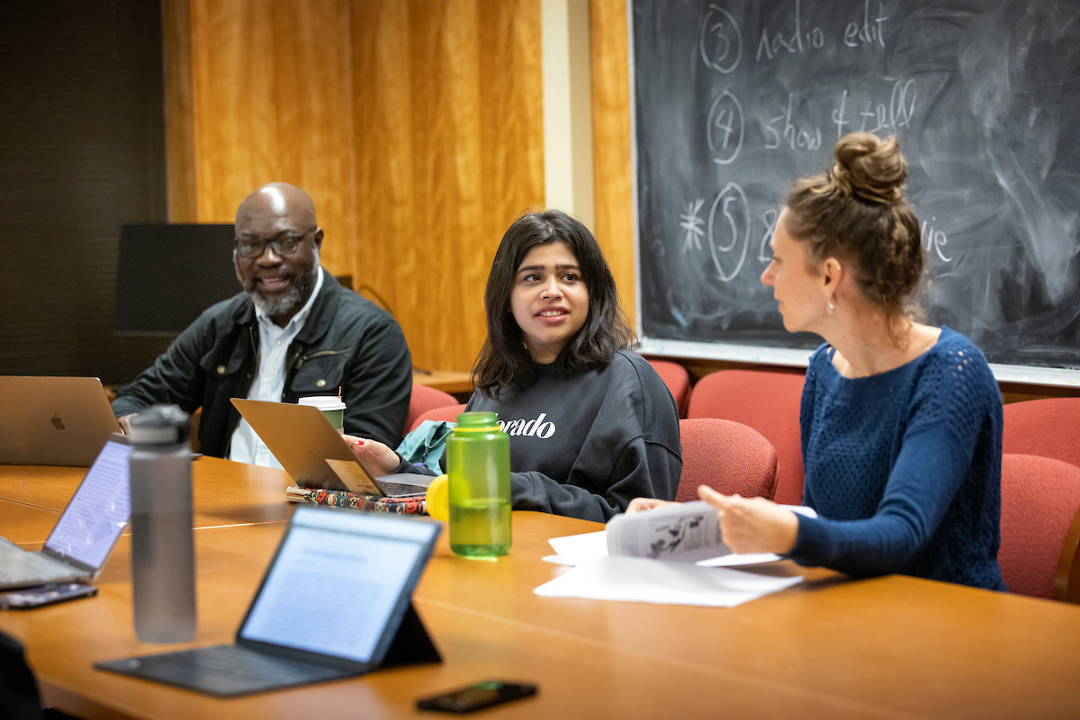 students speaking at a table
