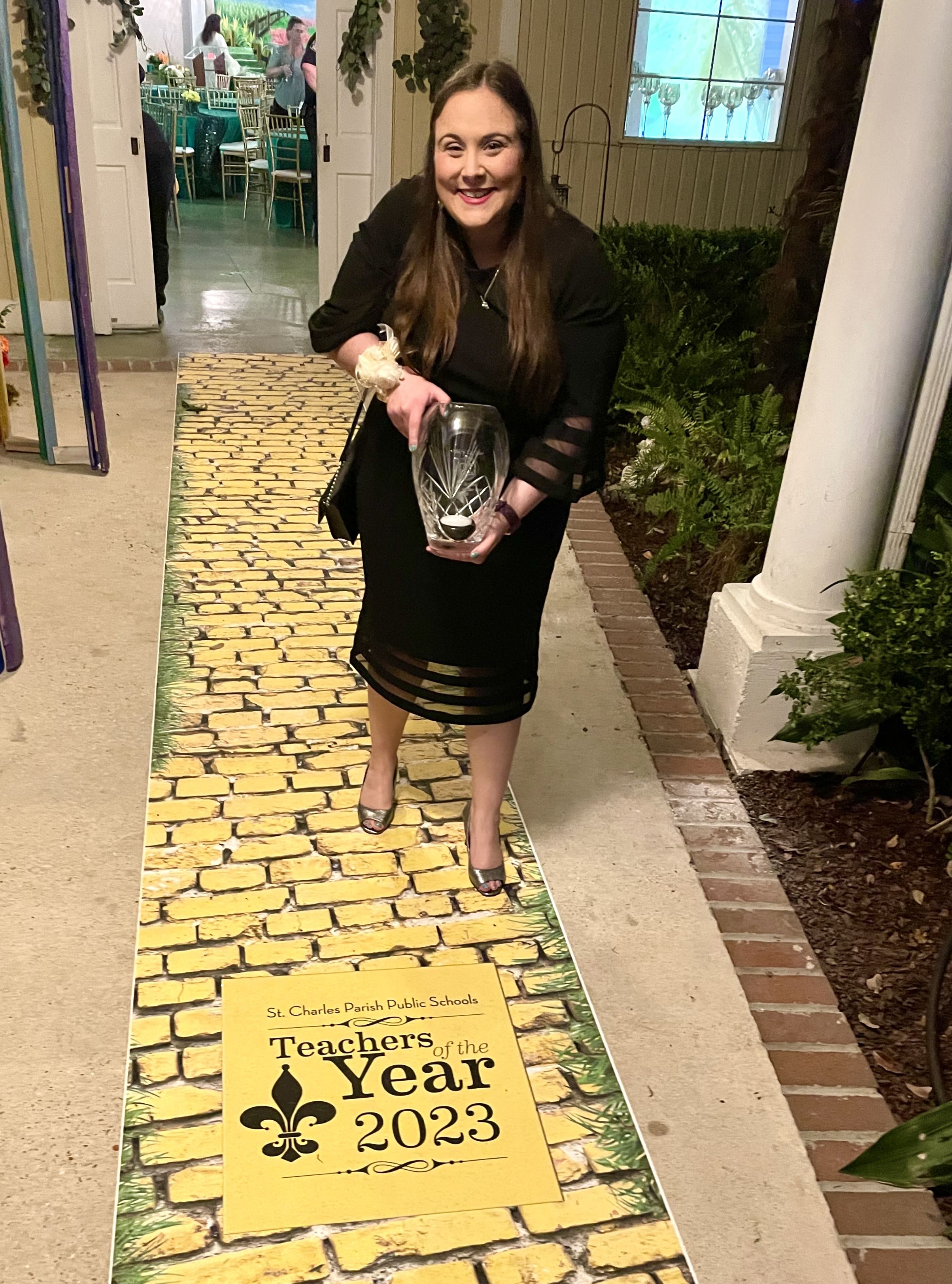 macy-lafleur-teacher-of-the-year Macy holding a glass award for District Teacher of the Year