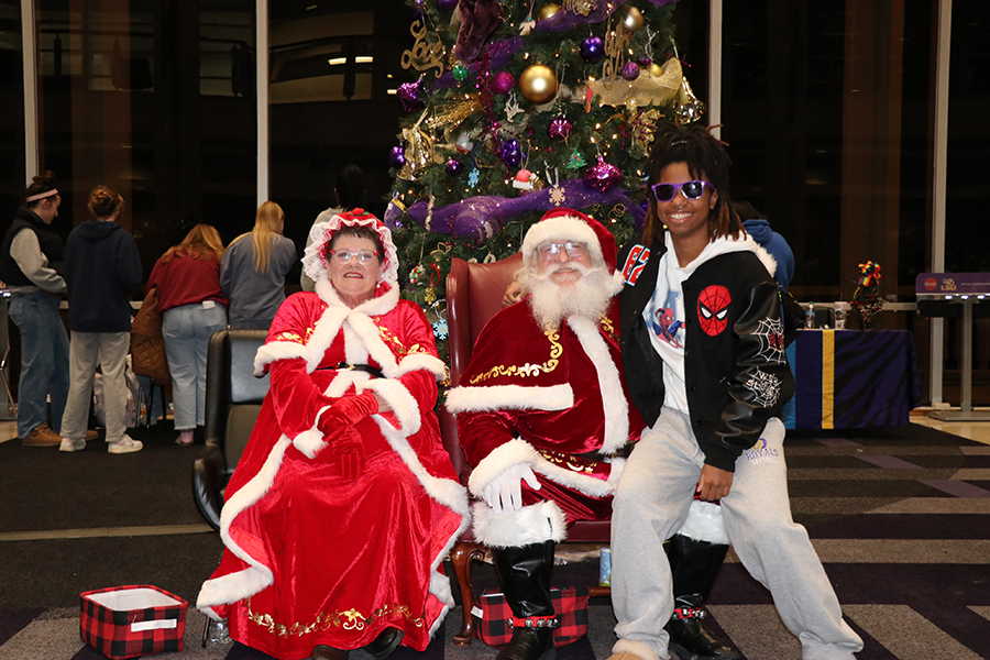 young man with Santa and Mrs. Claus