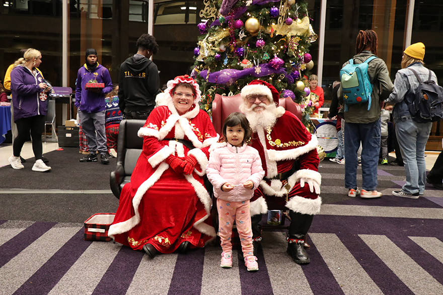 child with Santa and Mrs. Claus